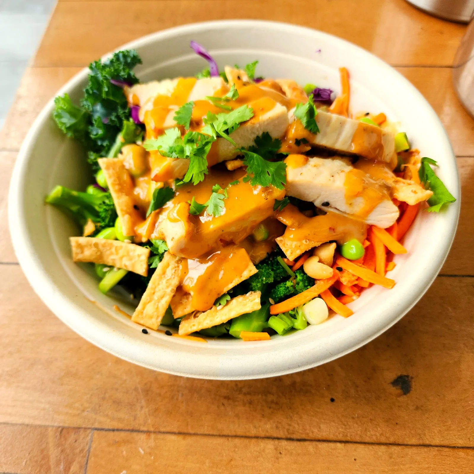 Freshii Buddha Satay bowl with chicken, rice noodles, broccoli, carrots and peanut sauce