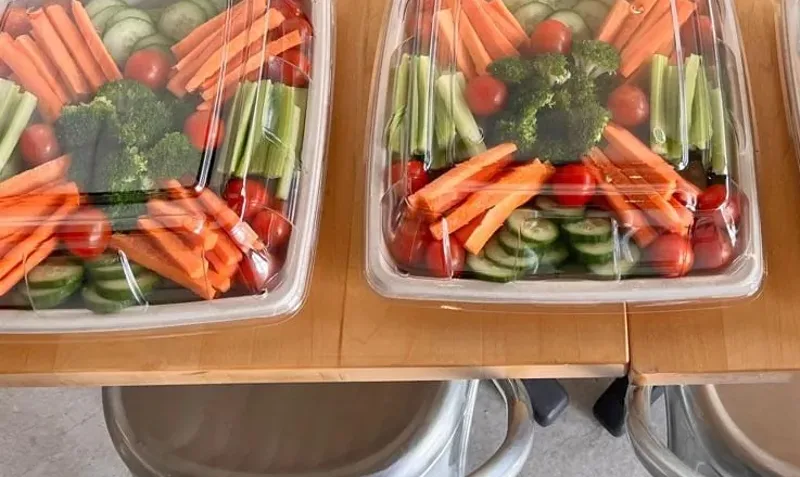 Veggie platters with carrots, cucumber, broccoli and tomatoes packed for a Freshii Sundance catering order