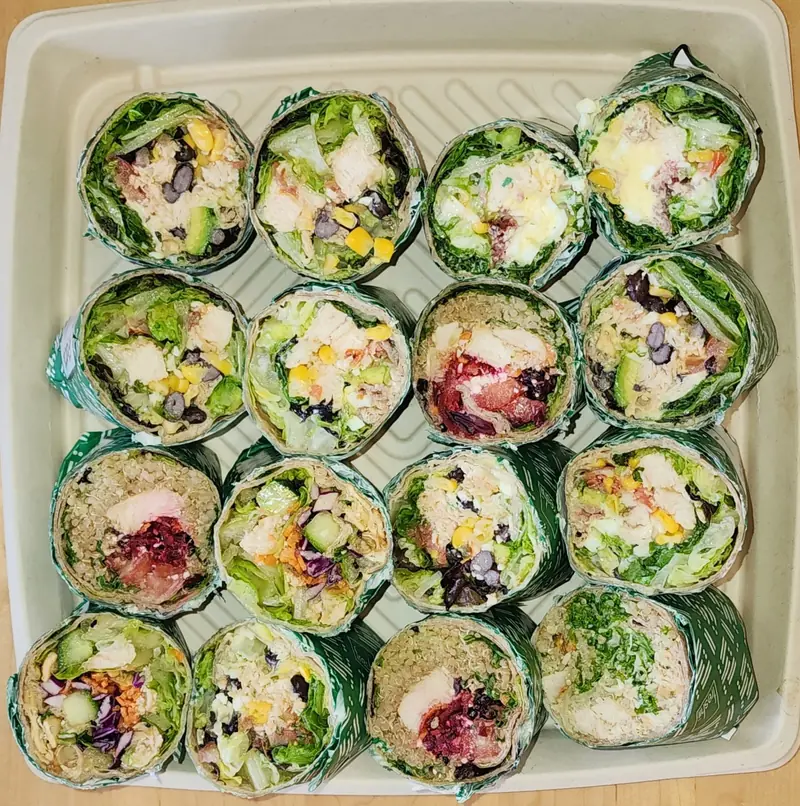 Wraps cut in half and packed in a catering platter at Freshii Sundance